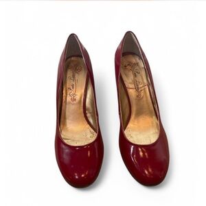 Poetic License Burgundy patent leather wedge heels with leopard print wedge.